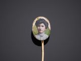 a close up of a wooden stick with a picture of a woman on it