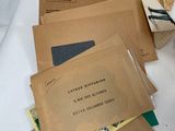 many brown envelopes on a white table cloth