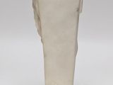 statue of a woman holding a vase on a white surface