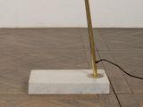 a lamp that is sitting on a block on the floor