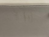a close up of the bottom of a white leather purse