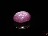 a picture of a purple stone on a black surface
