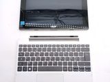 a laptop computer sitting on top of a white table