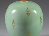 a green vase with a gold leaf design on it