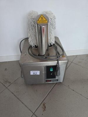 a mop sitting on top of a machine on the floor