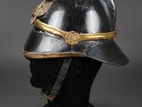 an old helmet with a gold band on top of it