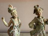 two figurines of women dressed in fancy clothing