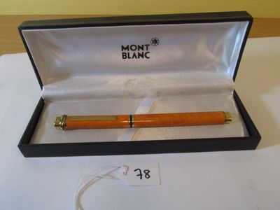 a pen in a box on a table with a price tag
