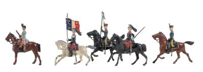 five figurines of men riding horses and holding flags