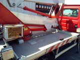 a red truck with a crane on the back of it