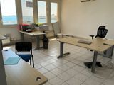 a room with a desk, chair, and a computer on it