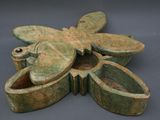 a green box with a dragonfly on top of it