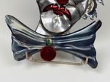 a silver clown with a red nose and a bow tie