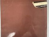 a book with a gun on top of it sitting on a table