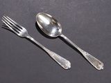 two spoons and a fork on a table