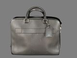 a grey briefcase with a tag on it sitting on top of a table