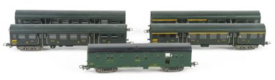 three green and yellow train cars sitting next to each other on a white surface
