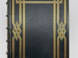a black and gold book with a gold border on it