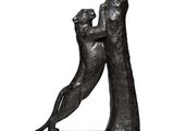 sculpture of two cats playing with each other on a white surface
