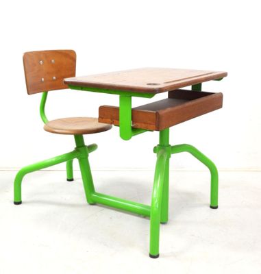 a green desk and a wooden chair in a room