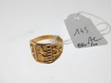 une image d'une bague en or sur une surface blanche avec une étiquette de prix