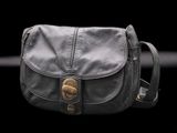 an image of a black purse on a black background
