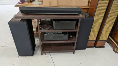 a wooden shelf with speakers and a stereo on top of it