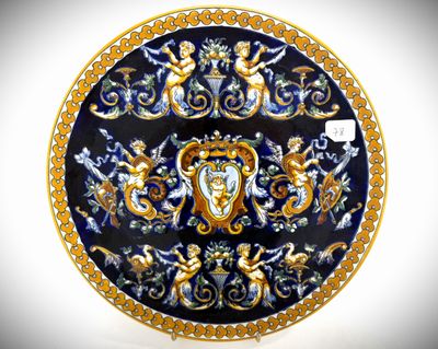 a blue and gold plate with a picture of angels on it