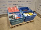 three bins of assorted items sitting on a pallet