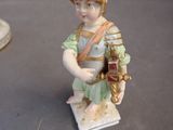 a figurine of a boy in a roman soldier costume