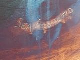 a close up of a painting of a dog on a table