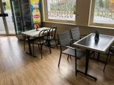 a table and chairs in a room with a large window