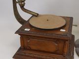 an old record player with a wooden base and a metal stand