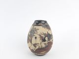 a small vase with a painting on it on a white surface