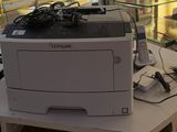 a printer sitting on top of a table in front of a glass case