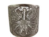 an image of a silver cuff bracelet with a flower design on it