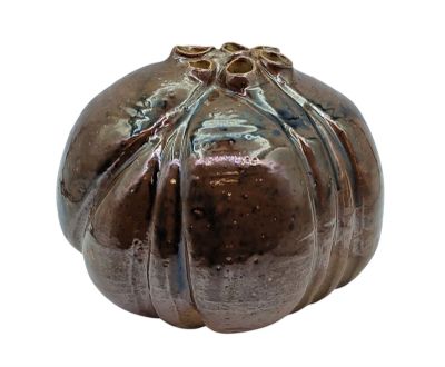 a brown vase that is sitting on a white surface