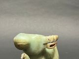 a small figurine of an elephant sitting on a table