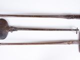 three old tools are sitting on a white surface with a white background