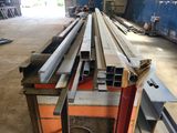 many pieces of steel on a table in a warehouse