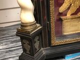 a clock that is sitting on a table in front of a window