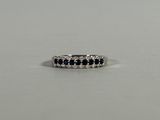 a white gold ring with black and white diamonds