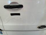 a close up of a car door handle with a sticker on it