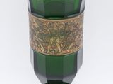 a green glass vase with a gold band around it