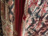 an image of a close up of a red and black shawl