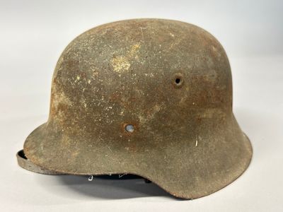 an old helmet on a white surface with a white background