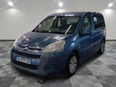 the small blue van is parked on a checkered tile floor