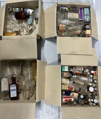 four boxes filled with bottles and bottles sitting on top of a table