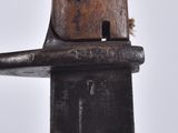 a close up of a knife with a bird on top of it
