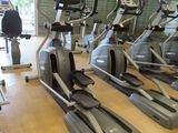 a row of stationary exercise bikes in a gym